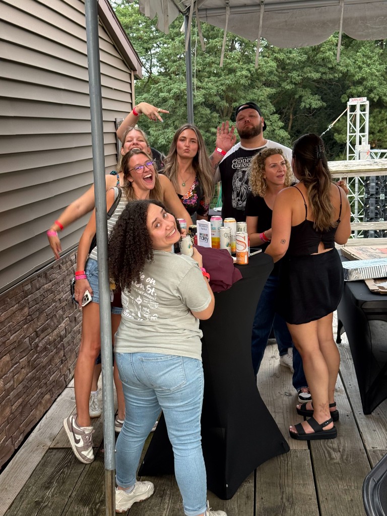 Haley Marketing teammates laughing together at an outdoor company event
